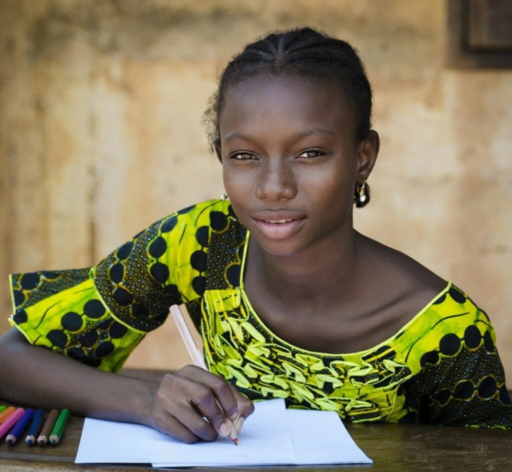 stock photo education symbol african girl sitting on her desk drawing 246575107 transformed.jpeg